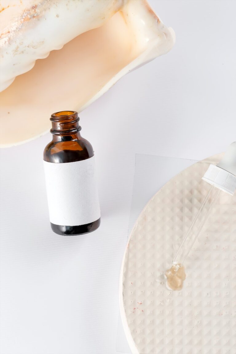 Skin oil on a white background. Homeopathic medicine in a transparent bottle with a pipette